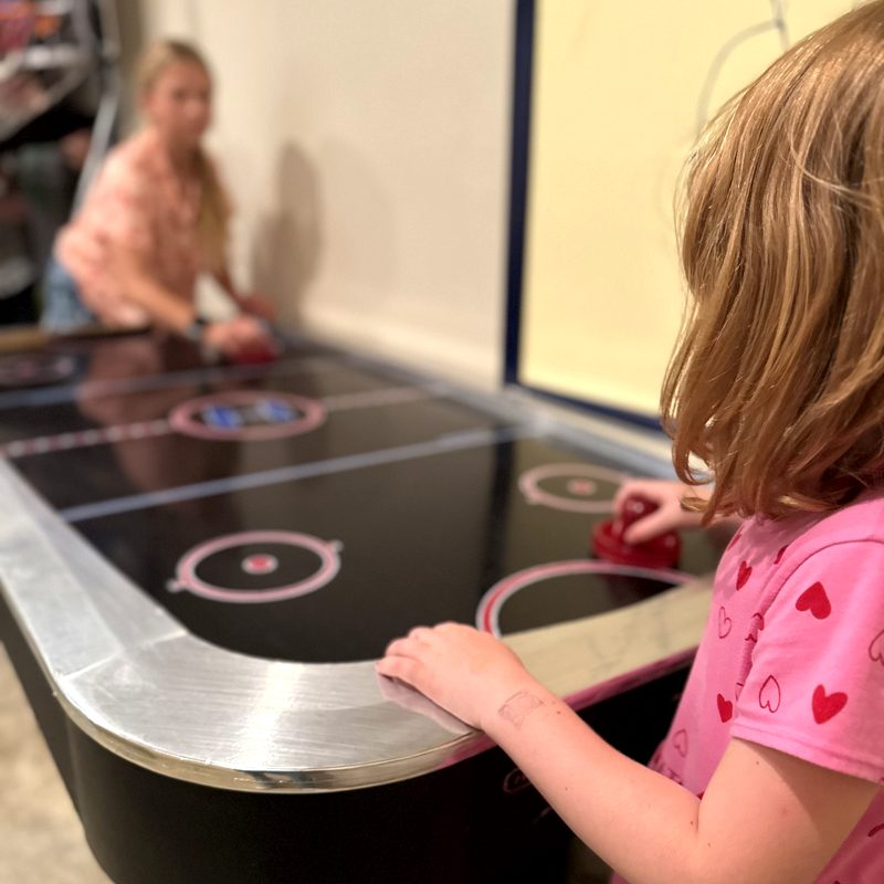 Kids playing air hockey