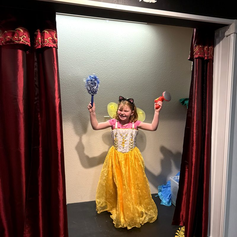 A girl in a dress-up costume on the Cason's Place stage