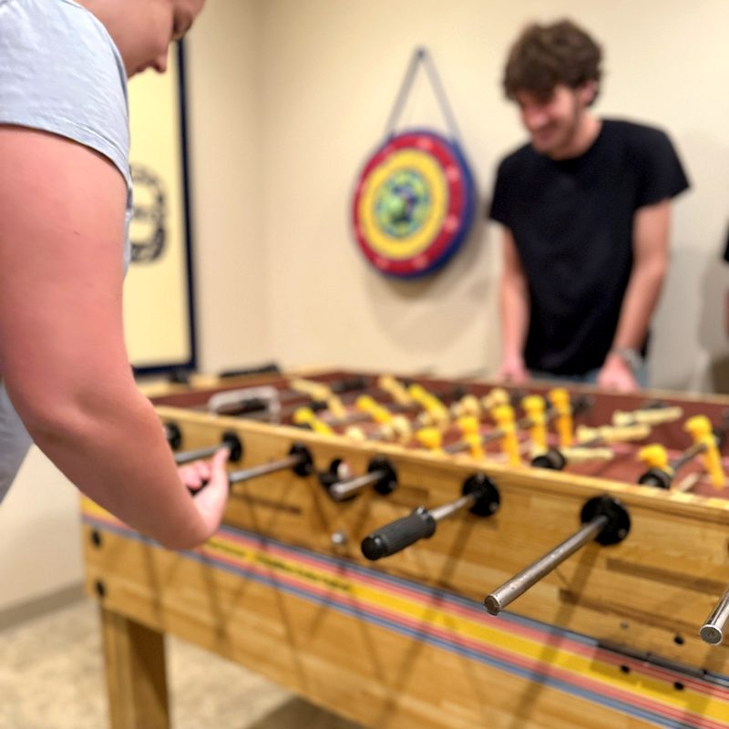 Teens playing foosball